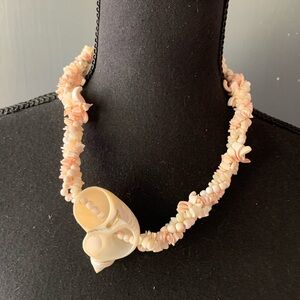 Chunky braided multi strand pika shell necklace, half sea shell barrel clasp